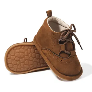 Dark brown suede baby boots with anti-slip rubber soles and brogue lace-up detail
