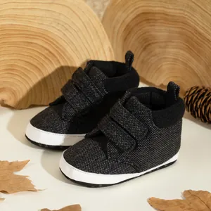 Close-up of soft-sole baby shoes with tweed texture and double velcro straps