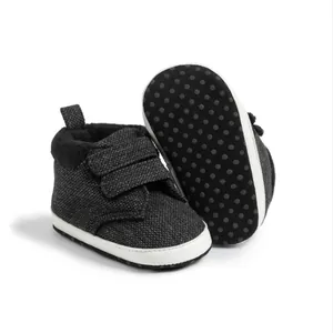 Detail view of baby high-top shoes featuring soft anti-slip dotted soles and velcro straps