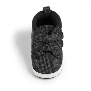 Detailed view of grey tweed baby shoes with dual velcro straps and soft padded collar
