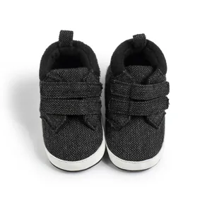 Detail view of baby high-top walking shoes with textured fabric and dual Velcro straps