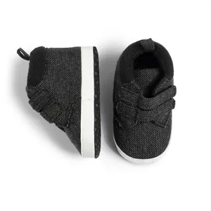 Detail of baby canvas sneakers featuring anti-slip dotted soles and velcro straps