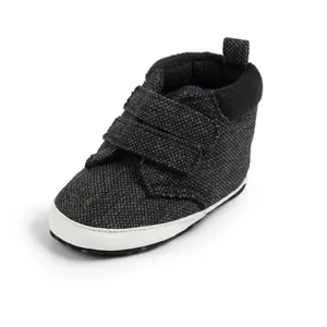 Dark grey baby high-top sneakers with velcro straps and soft white rubber soles