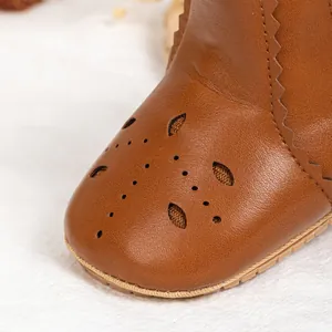 Brown leather baby walking shoes with hollow flower patterns and anti-slip rubber soles