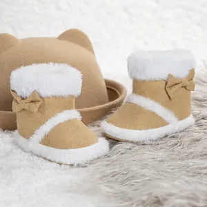 Detail of warm baby boots with soft soles, faux fur lining, and a cute bow decoration