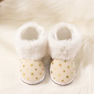 Detail view of baby snow boots with gold star print and soft plush fleece lining