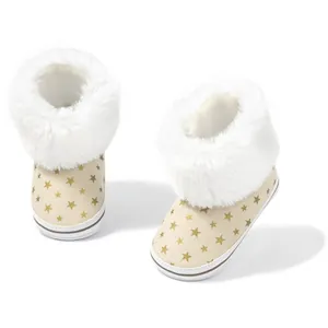Detail of baby snow boots with gold stars, faux suede and white faux fur trim