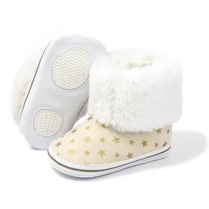 Detail showing non-slip star-patterned infant snow boots with soft sole and warm faux fur lining