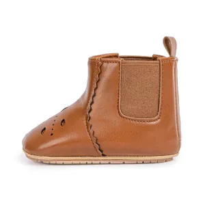 Classic dark brown baby Chelsea boots with non-slip rubber soles and breathable hollow patterns