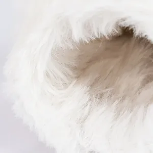 Close-up of thick cream faux fur lining inside warm winter baby boots for girls