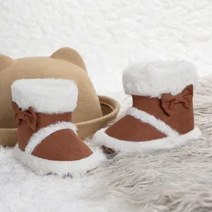 Detail of baby winter boots with warm faux fur lining and a decorative side bow