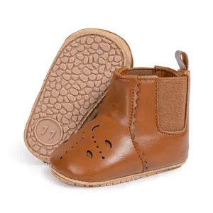 Detail of baby Chelsea boots featuring hollow petal cutouts and non-slip rubber soles