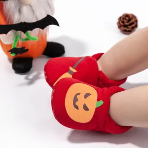 Detailed view of Halloween baby shoes with pumpkin print and elastic ankle support