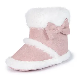 Close-up of pink baby boots featuring soft faux fur trim and decorative bow detail