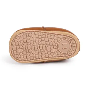 Detail of non-slip rubber sole with pebble texture and size 11 marking on baby boot