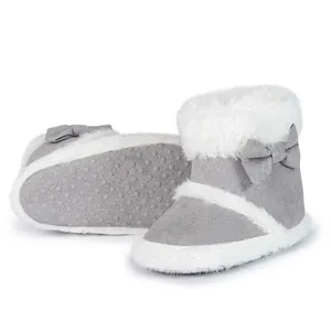 Detail view of anti-slip soles and plush lining on gray infant bow winter boots