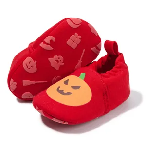 Detail of red Halloween baby shoes with pumpkin motifs and non-slip soft soles