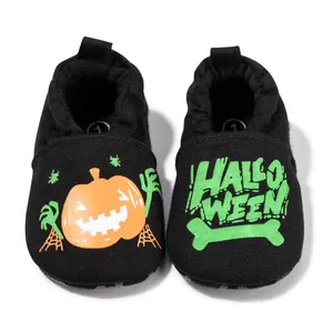 Detailed top view of Halloween baby shoes with pumpkin print and elastic ankle cuffs
