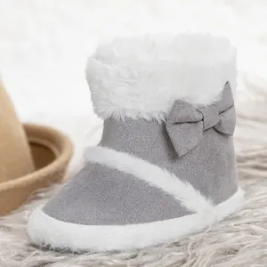 Gray baby snow boots with soft suede and white faux fur lining featuring a bow decoration