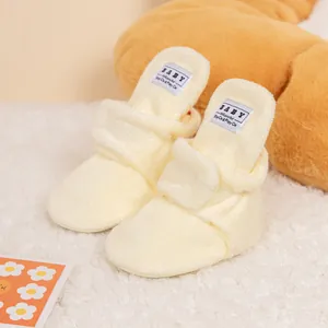 Plush cream baby walking shoes with warm fleece material and soft non-slip soles
