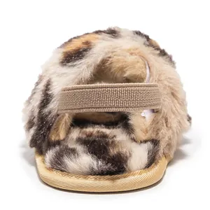 Detailed view of leopard print plush baby slipper with elastic heel strap and soft sole