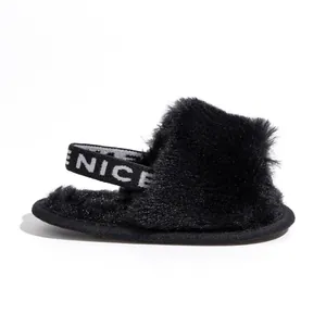 Detail of plush baby slipper with black faux fur and elastic NICE backstrap