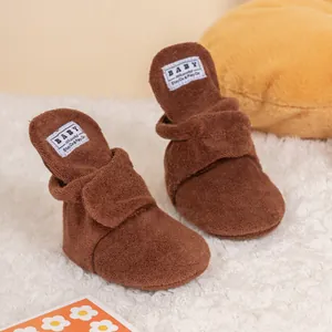 Plush brown baby walking shoes with soft fleece lining and adjustable velcro strap
