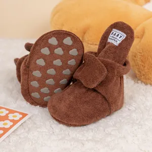 Detail view of baby walking shoes with plush lining and non-slip cloud-shaped sole pads