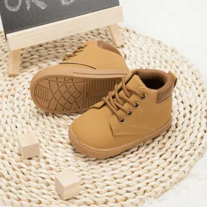 Close-up of children's brown PU leather high-top boots with durable non-slip rubber soles