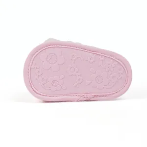 Close-up of pink baby walker shoe sole featuring anti-slip floral patterns on soft fabric