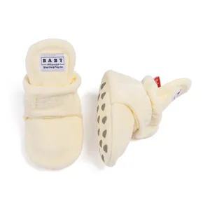 Detail of warm plush baby walking shoes showing non-slip soles and velcro straps
