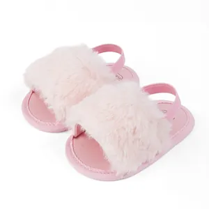 Detailed view of pink plush baby slippers with soft faux fur and elastic heel strap