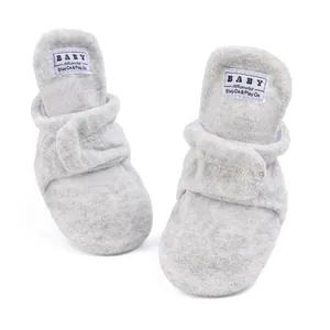 Detail of plush baby walking shoes with Velcro straps and soft faux shearling material