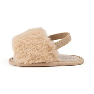 Detail of plush baby slippers with elastic back strap and soft sole for 0-6 months