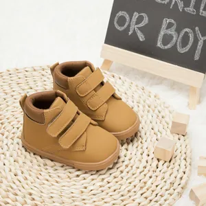 Detail of infant walking shoes with double hook-and-loop straps and non-slip rubber soles
