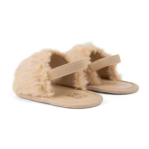 Detail of baby plush slingback slipper in apricot showing soft texture and elastic strap