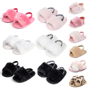 Detail of plush baby slides showing soft fur texture and elastic heel straps in various colors
