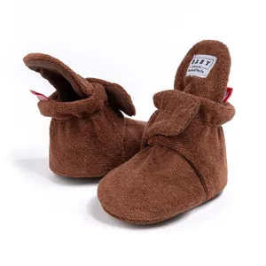 Detailed view of warm brown plush baby walking boots with soft non-slip soles