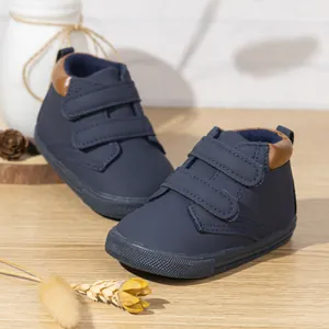 Navy blue toddler shoes featuring dual Velcro straps and anti-slip rubber soles for safety