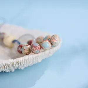 Ciondolo in pietra Shoushan 10mm con motivo a leone e perle di pietra oceanica blu marina
