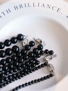 Macro shot of high-quality black onyx beads with S925 sterling silver lobster clasp detail