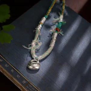 Collier artisanal tibétain en forme de bourse avec pendentif serrure de longévité en argent