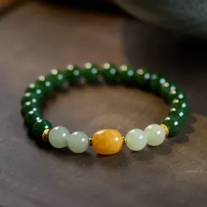 Detail of vintage jasper bracelet with amber beads and ornate gold metal spacers
