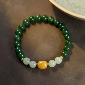 Detailed close-up of natural jasper beads with amber and gold retro metal spacers