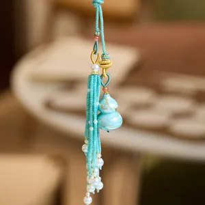 Pendentif gourde laqué bleu marbré avec glands en perles et accents dorés