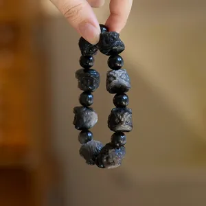 Bracciale maschile con perle di ossidiana naturale e ciondolo a testa di leone