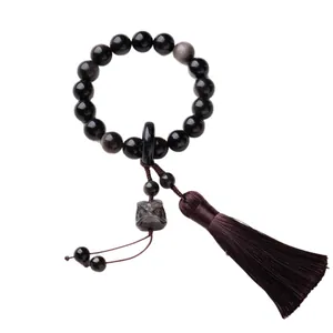 Bracciale di perle in ossidiana naturale con ciondolo leone nero e nappina viola