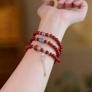 Three-layer red agate bead bracelet with silver leaf pendant and blue spacer bead decor