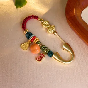 Golden zodiac horse brooch with traditional knots, gourd pendant and colorful beads