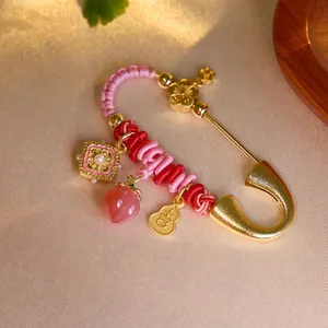 Exquisite gold zodiac horse brooch with pink heart stone and pearl on silk fabric